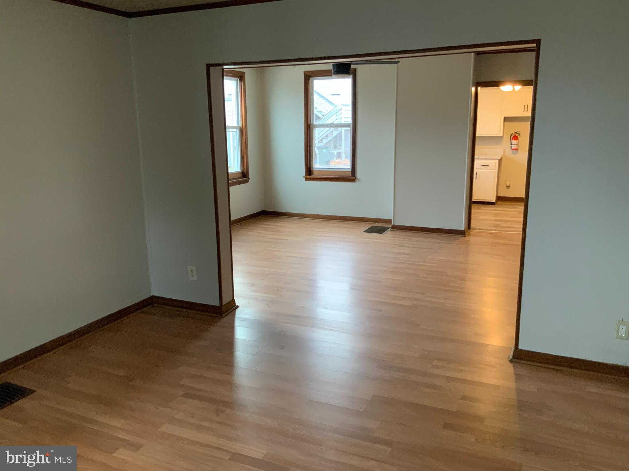 334 Blue Bell Road Williamstown, NJ 08094 - Photo 6 of 18 an empty room with wooden floor and windows