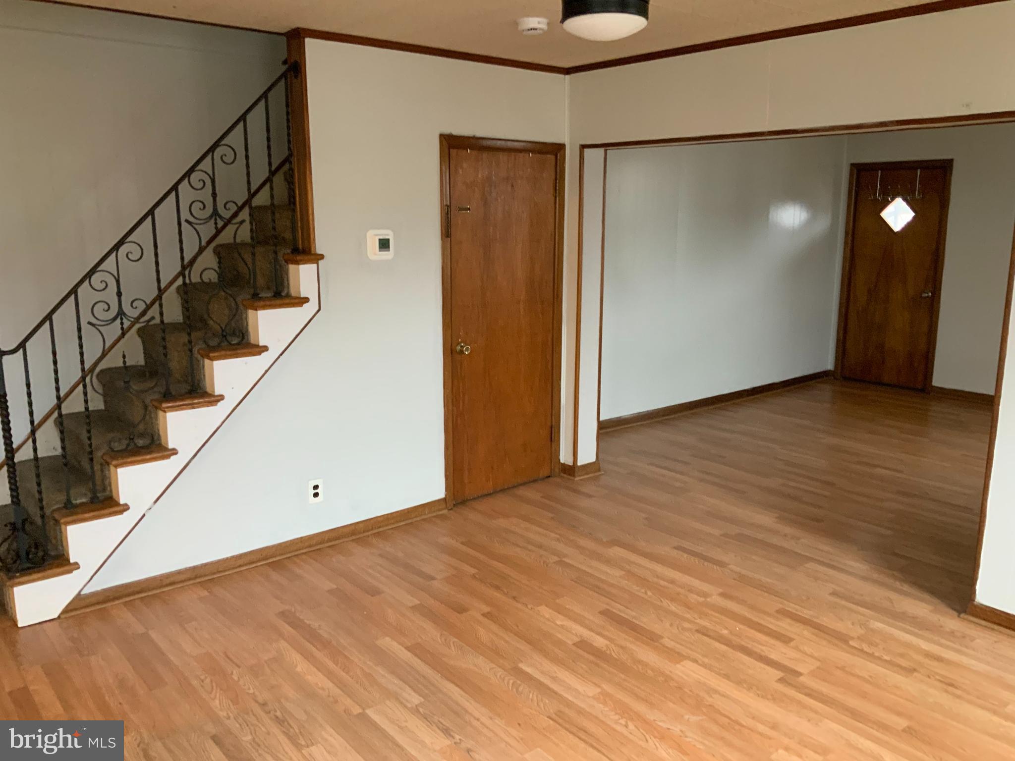 334 Blue Bell Road Williamstown, NJ 08094 - Photo 7 of 18 a view of an empty room with wooden floor and stairs
