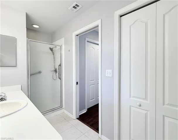 a bathroom with a sink and shower