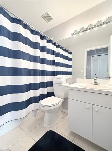 a bathroom with a sink a toilet a mirror and shower