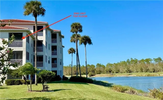 a front view of a house with a yard and palm trees