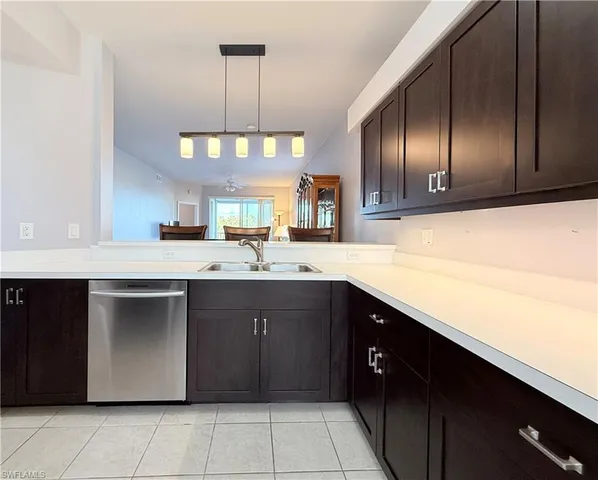 a kitchen with a sink cabinets and window
