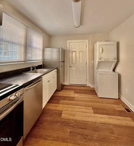 a kitchen with granite countertop a sink and a stove top oven