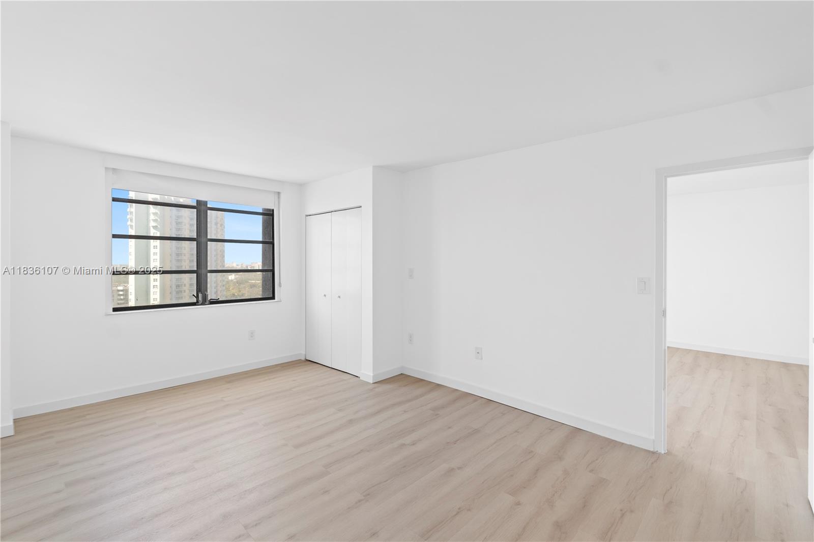 2333 Brickell Avenue, Unit 1908 Miami, FL 33129 - Photo 18 of 29 an empty room with wooden floor and windows