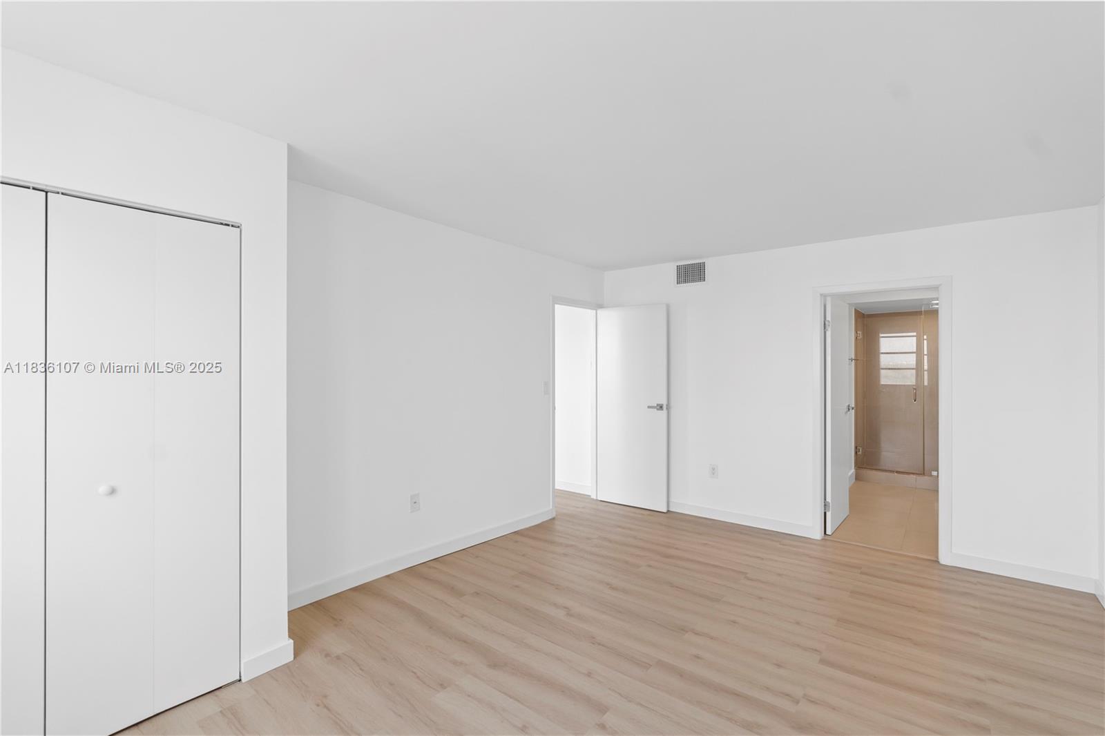 2333 Brickell Avenue, Unit 1908 Miami, FL 33129 - Photo 19 of 29 a view of an empty room with wooden floor