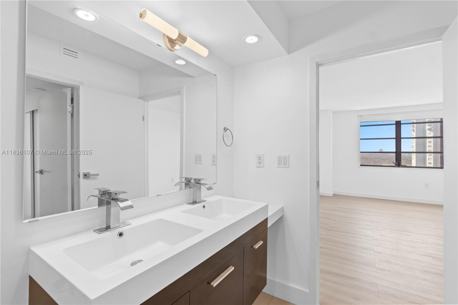 2333 Brickell Avenue, Unit 1908 Miami, FL 33129 - Photo 21 of 29 a bathroom with a sink a shower and a mirror