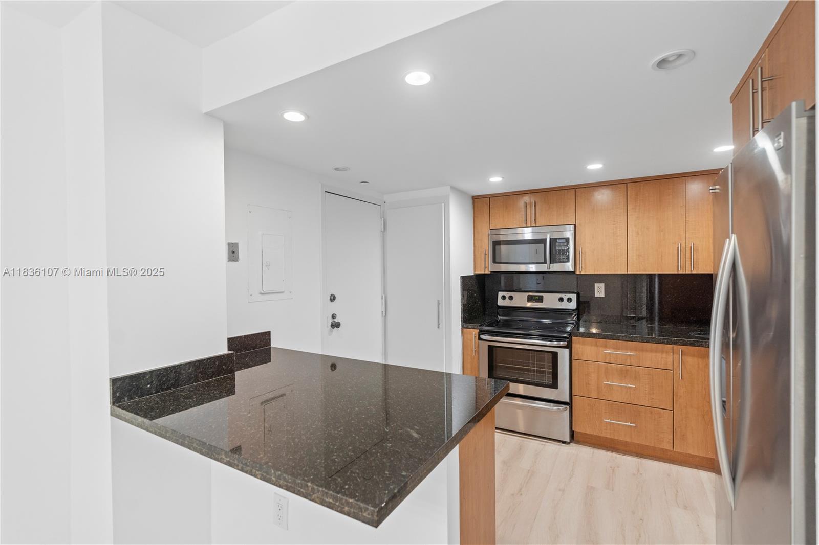 2333 Brickell Avenue, Unit 1908 Miami, FL 33129 - Photo 4 of 29 a kitchen with stainless steel appliances granite countertop a sink a stove and a refrigerator