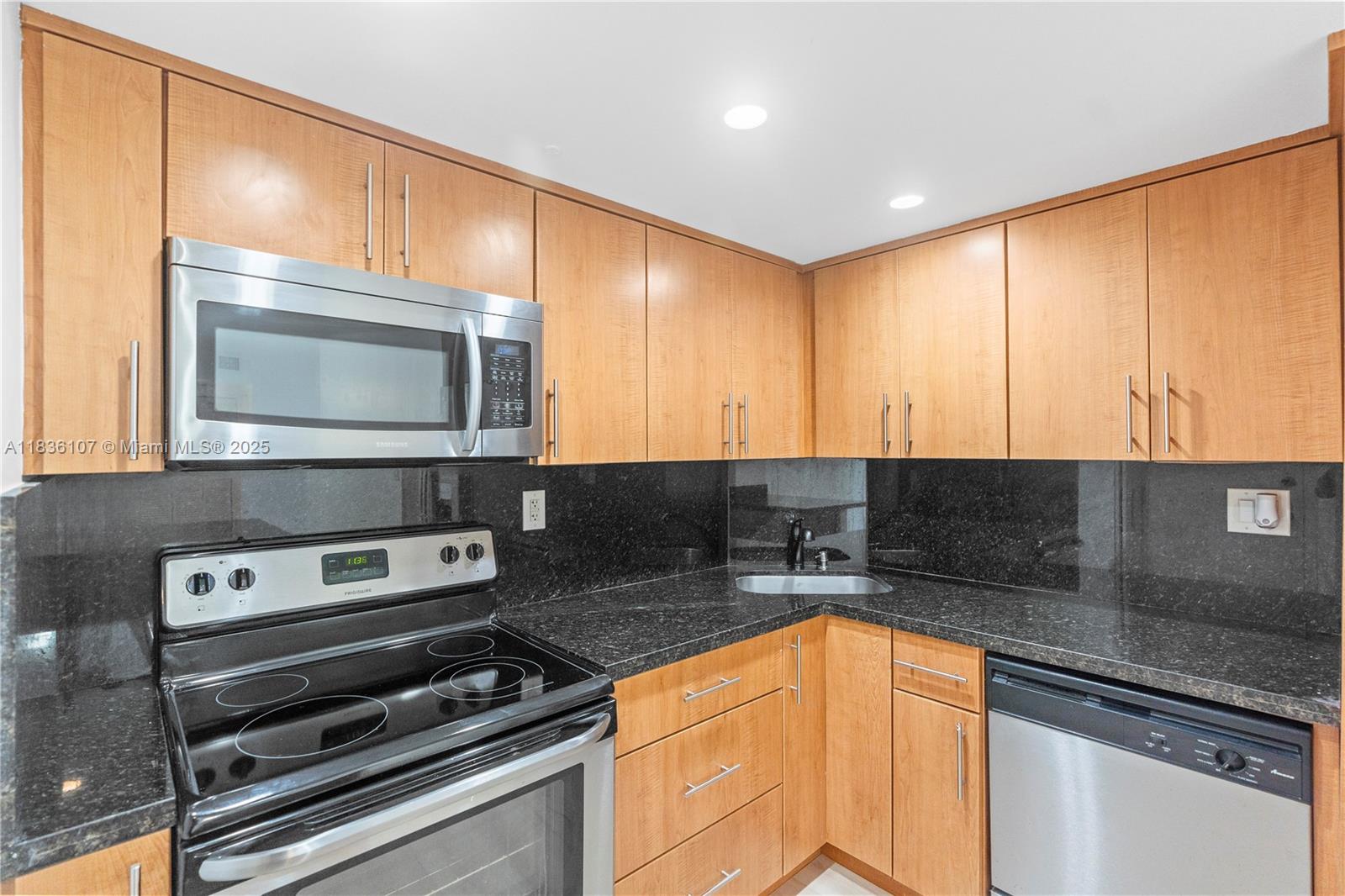 2333 Brickell Avenue, Unit 1908 Miami, FL 33129 - Photo 6 of 29 a kitchen with stainless steel appliances a stove sink and cabinets