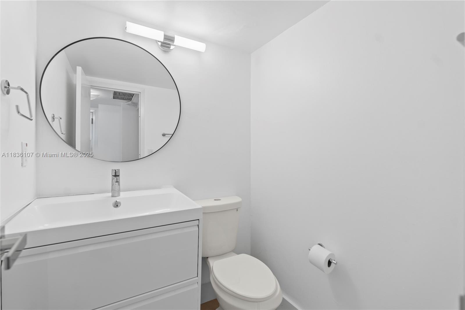 2333 Brickell Avenue, Unit 1908 Miami, FL 33129 - Photo 8 of 29 a bathroom with a toilet a sink and mirror