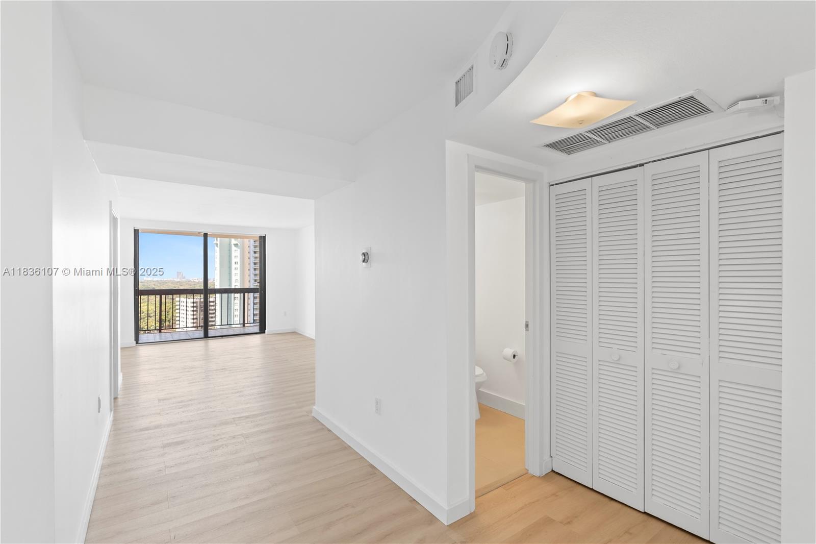 2333 Brickell Avenue, Unit 1908 Miami, FL 33129 - Photo 9 of 29 a view of an empty room with wooden floor and a window