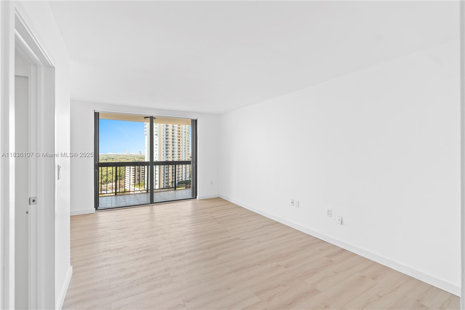 2333 Brickell Avenue, Unit 1908 Miami, FL 33129 - Photo 10 of 29 an empty room with wooden floor and windows