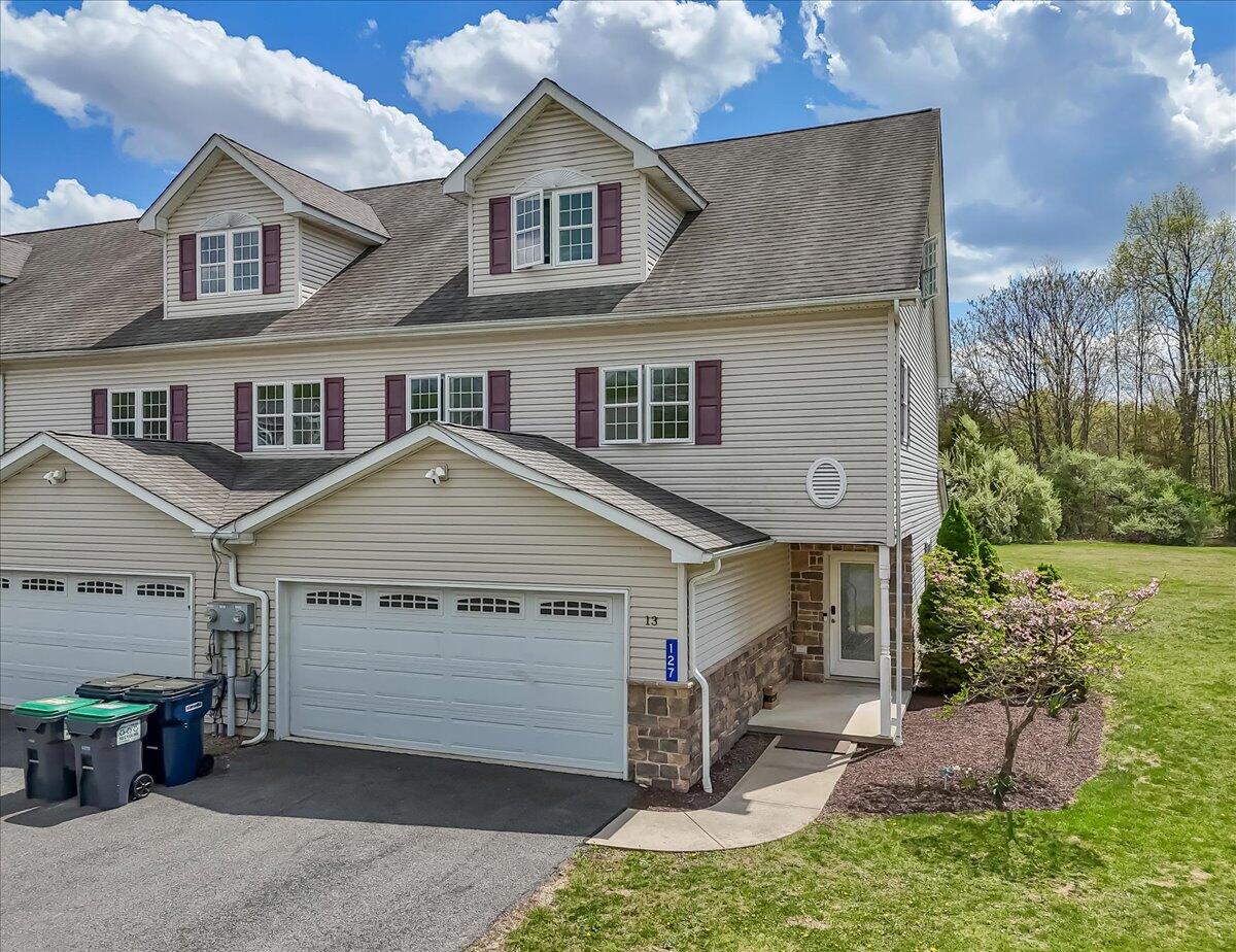 a front view of a house with a yard and garage