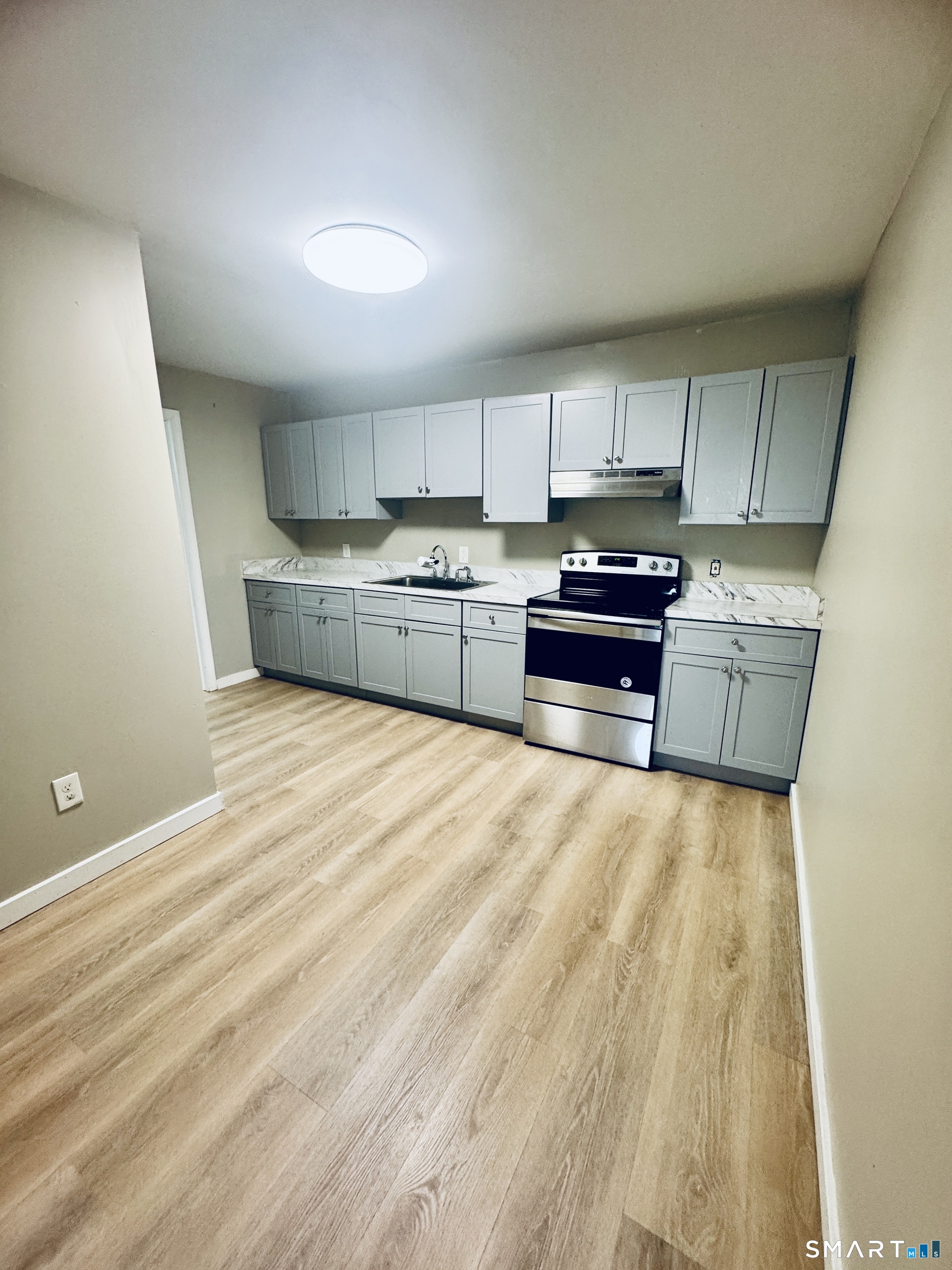 124 Meriden Road Waterbury, CT 06705 - Photo 2 of 5 a kitchen with stainless steel appliances granite countertop a stove a refrigerator and a sink