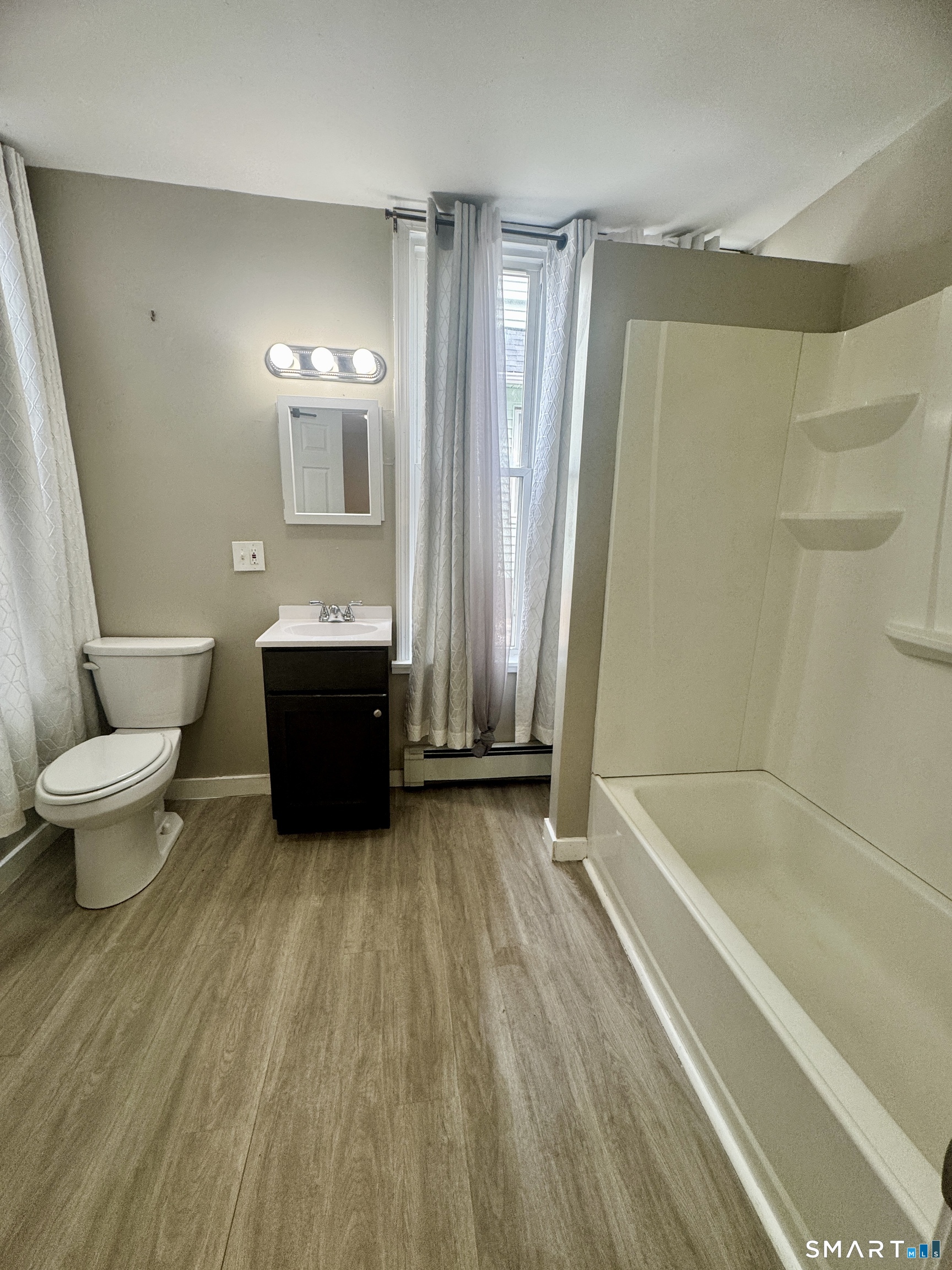 124 Meriden Road Waterbury, CT 06705 - Photo 4 of 5 a bathroom with a sink a toilet and a bathtub