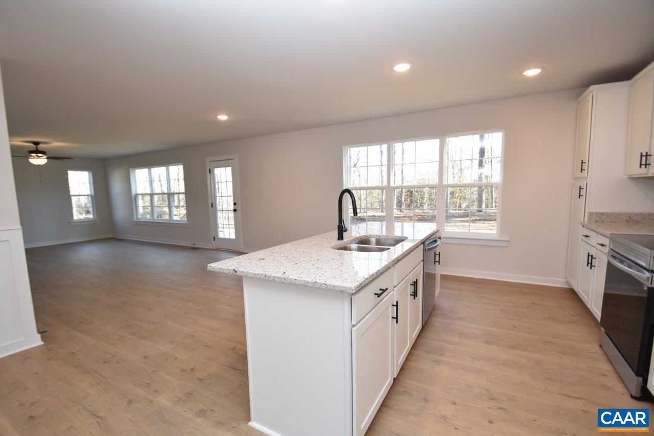 0 Lake Road, Unit HL12A Troy, VA 22974 - Photo 12 of 36 a large kitchen with granite countertop a sink and dishwasher a stove top oven with wooden floor