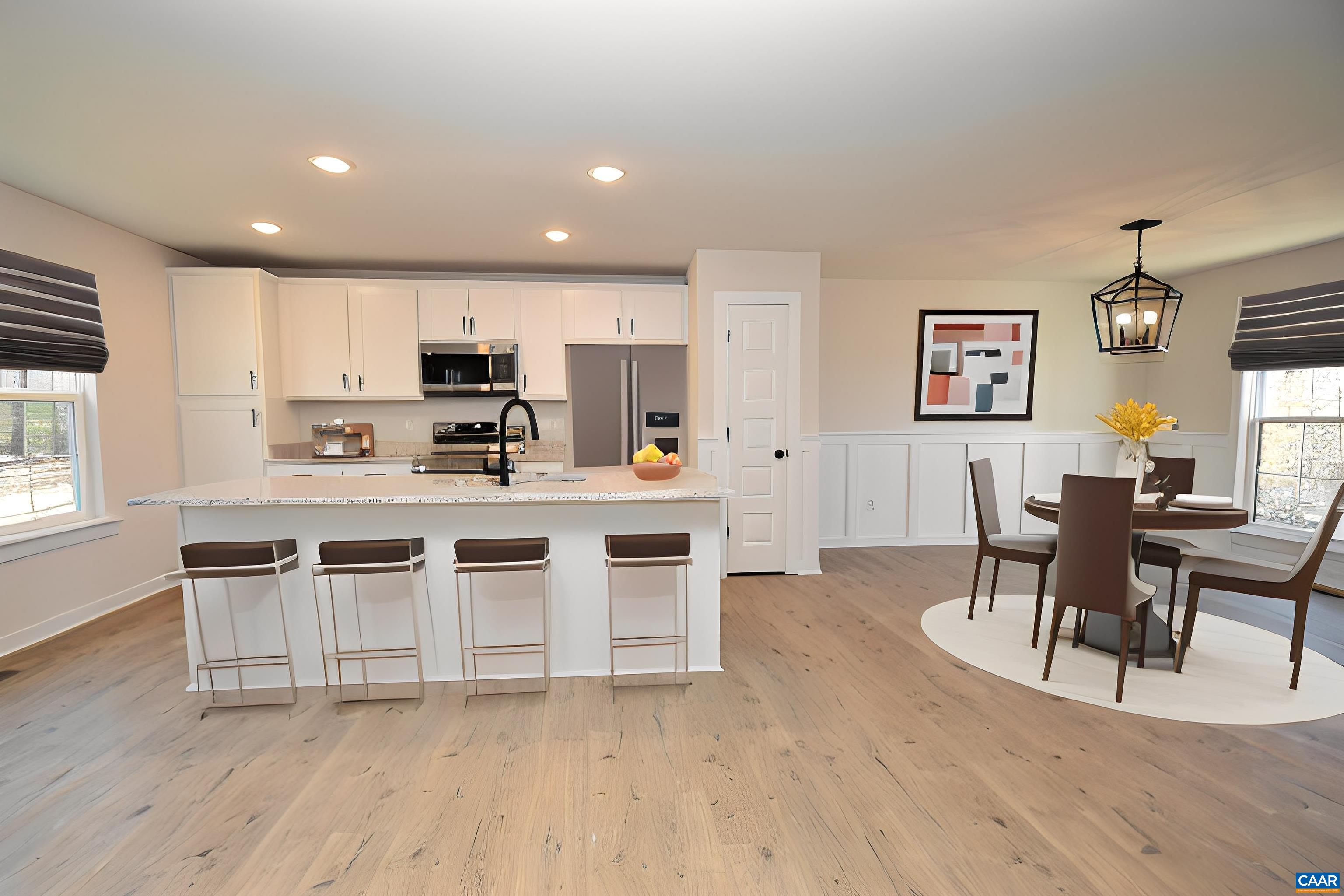 0 Lake Road, Unit HL12A Troy, VA 22974 - Photo 4 of 36 a kitchen with stainless steel appliances a table and chairs in it