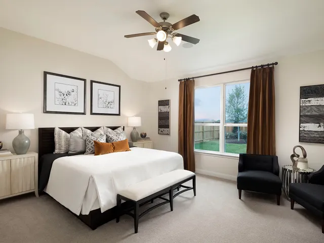 a bedroom with a bed and a couch next to a window