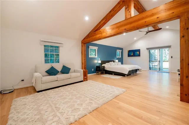 a bedroom with furniture and wooden floor