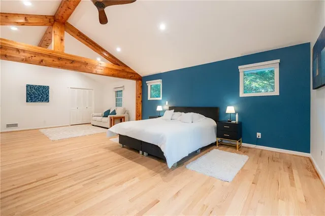 a bedroom with a large bed and a chandelier