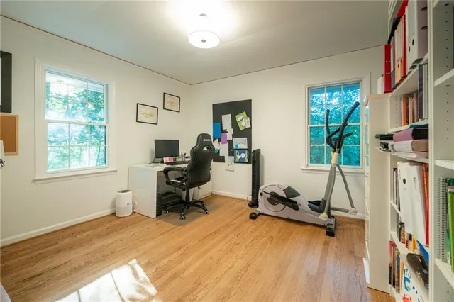 a view of a livingroom with workspace and a window