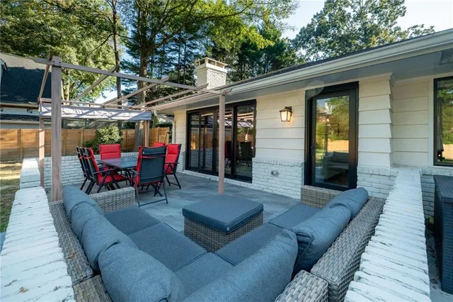 a outdoor space with patio the couches and a flat screen tv