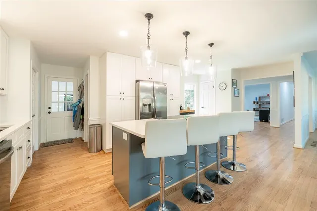 a dining room with furniture and wooden floor