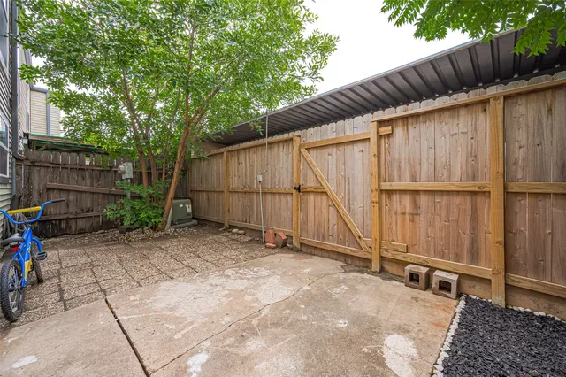 a view of a backyard with wooden fence