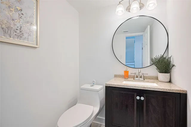 a bathroom with a toilet a sink and a mirror