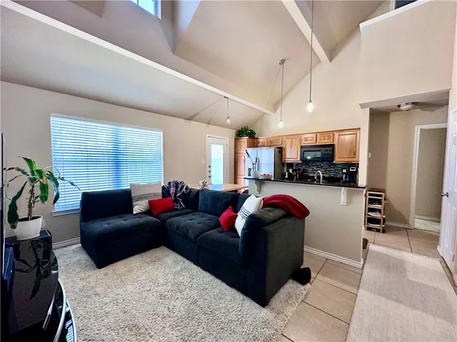 a living room with furniture fireplace and a window