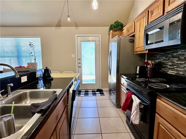 a kitchen with a sink appliances and cabinets