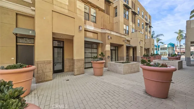 a view of a patio with couple of potted plants