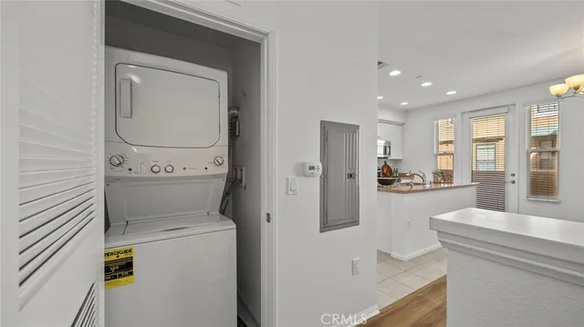 a view of washer and dryer with kitchen in the background