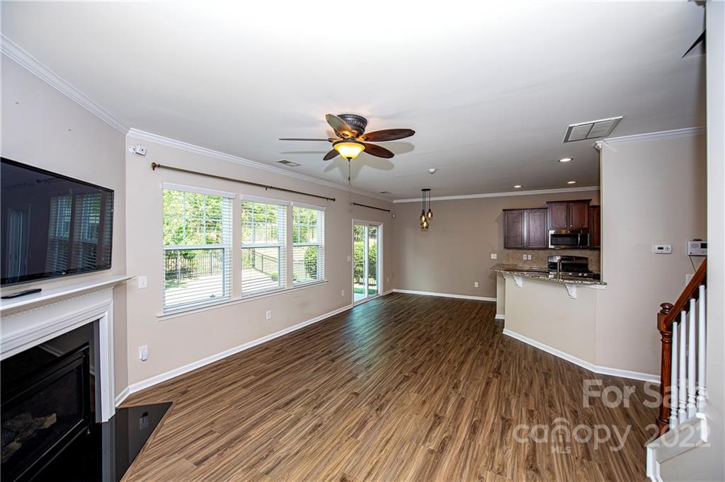 249 Catoctin Road Rock Hill, SC 29732 - Photo 13 of 30 a view of a kitchen with furniture a ceiling fan and wooden floor
