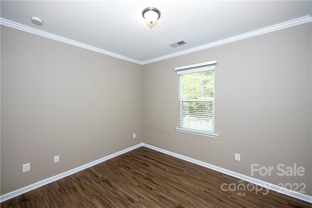 249 Catoctin Road Rock Hill, SC 29732 - Photo 14 of 30 a view of an empty room with wooden floor and a window