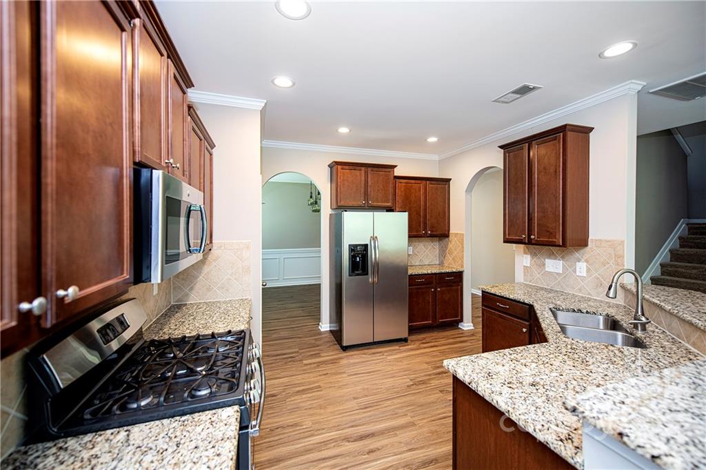 249 Catoctin Road Rock Hill, SC 29732 - Photo 6 of 30 a kitchen with stainless steel appliances granite countertop a refrigerator a stove and a sink