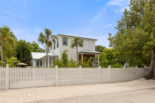a view of a house with a fence