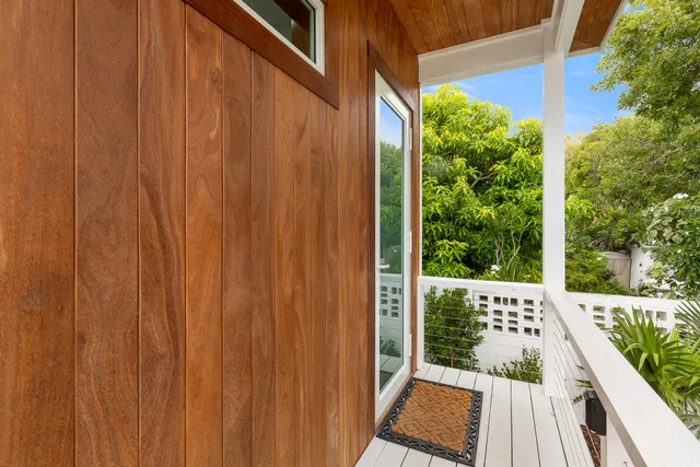 a view of a balcony with wooden floor and outdoor space