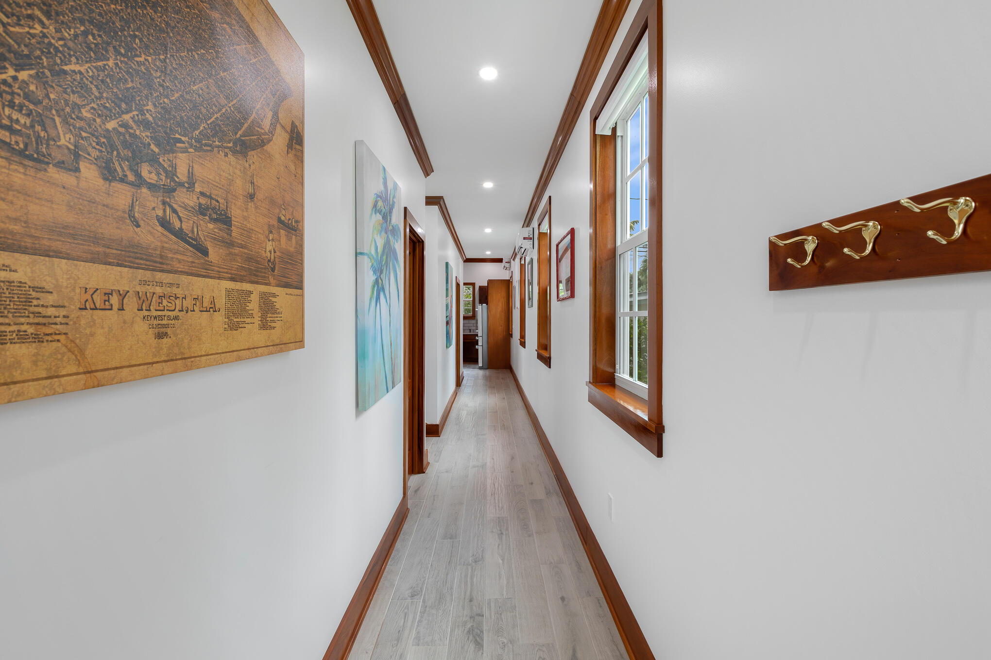 2214 Seidenberg Avenue Key West, FL 33040 - Photo 12 of 37 a view of a hallway with wooden floor and staircase