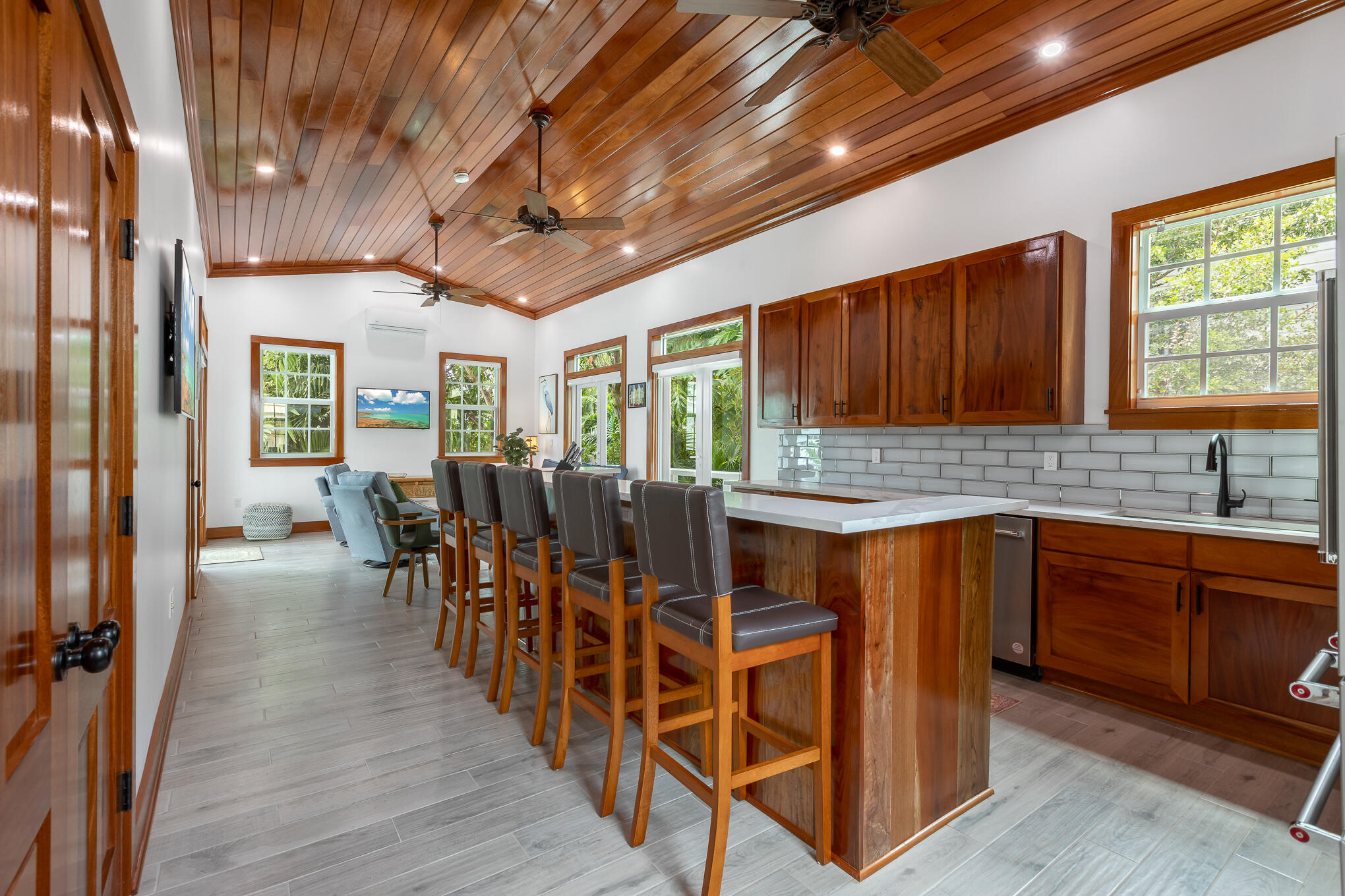 2214 Seidenberg Avenue Key West, FL 33040 - Photo 13 of 37 a open kitchen with stainless steel appliances granite countertop wooden floors a stove and white cabinets