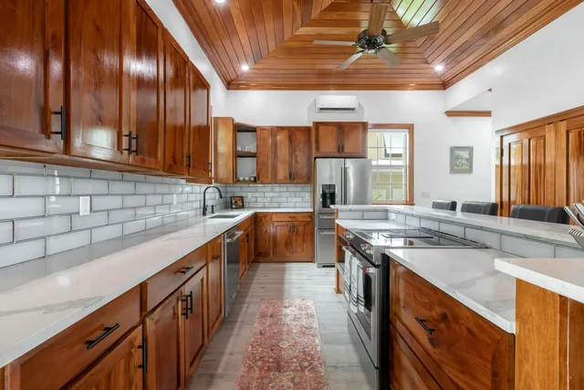 a kitchen with stainless steel appliances granite countertop counter top space a sink and a window
