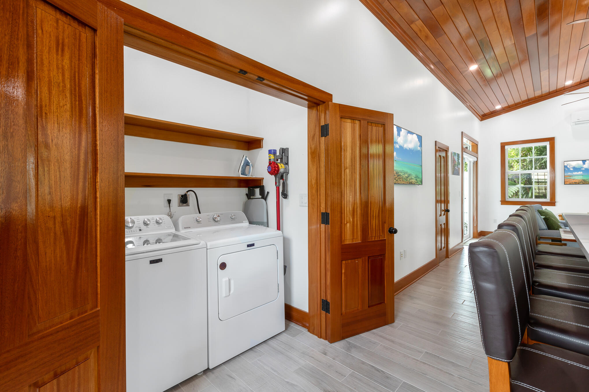 2214 Seidenberg Avenue Key West, FL 33040 - Photo 20 of 37 a hallway with white doors wooden floor and furniture