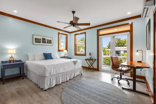 a bedroom with a bed and a large window