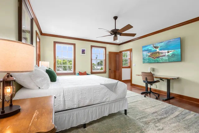 a bedroom with a large bed and a chandelier