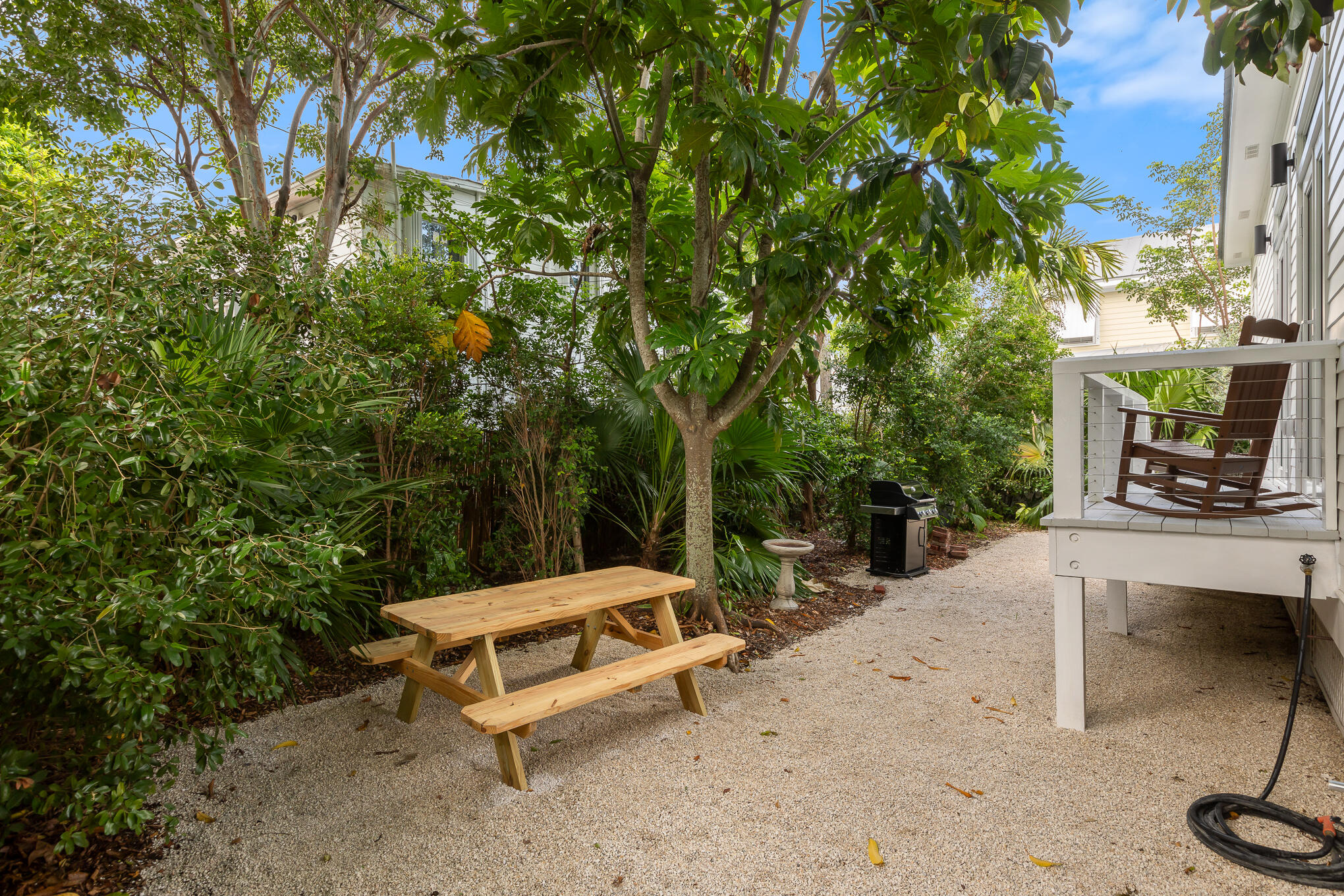 2214 Seidenberg Avenue Key West, FL 33040 - Photo 36 of 37 a bench sitting in the middle of a backyard