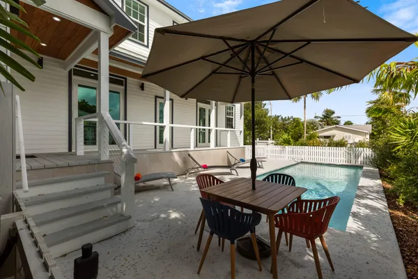 a patio with a patio table and chairs