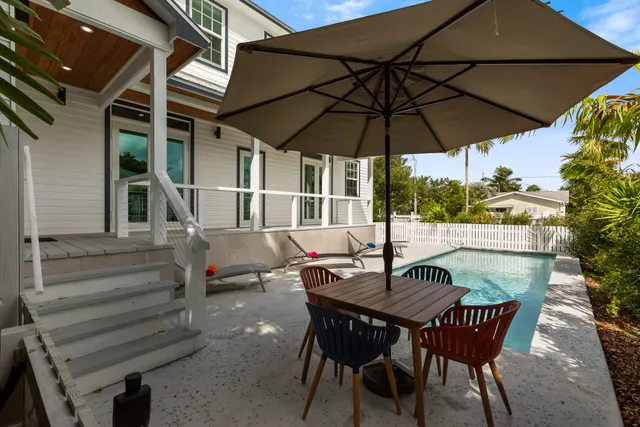 a patio with a patio table and chairs