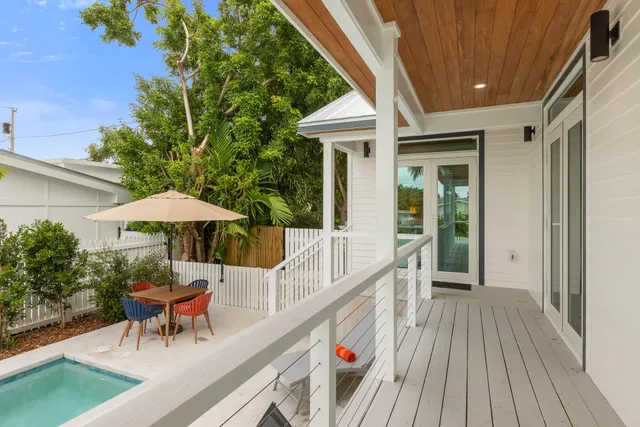 a view of a patio with a table and chairs