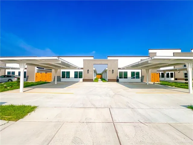 a front view of a building with a yard