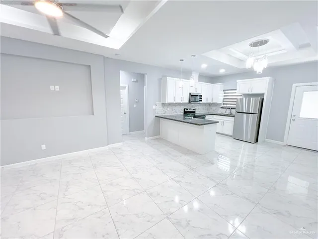 a view of a kitchen with a sink and a window