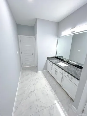 a bathroom with a granite countertop sink a toilet and a bathtub